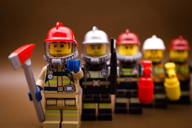 Varşova, Polonya, 19 Eylül 2023 İtfaiyeciler, takım olarak, bir sırada dururlar. Lego minyatür figürleri ve diğer tüm tuğlalar LEGO GROUP tarafından yapılmıştır..