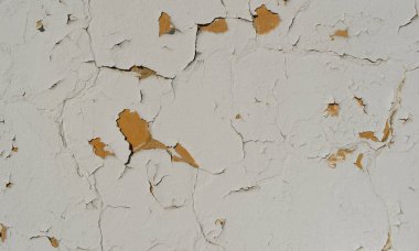 Lekeleri ve çatlakları olan eski beton bir duvar dokusu, beyaz kabuk soyma arka planı.