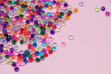 Pembe arka planda renkli boncuklar. Düz yatış, üst görünüm.