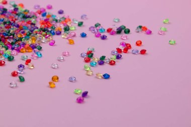 Pembe arka planda renkli boncuklar. Düz yatış, üst görünüm.