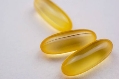 Beyaz arka planda balık yağı kapsülleri. Yakın plan. Makro.