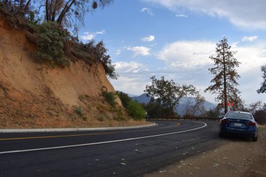 Dağlarda yol mavi gökyüzü ve arka planda beyaz bulutlar