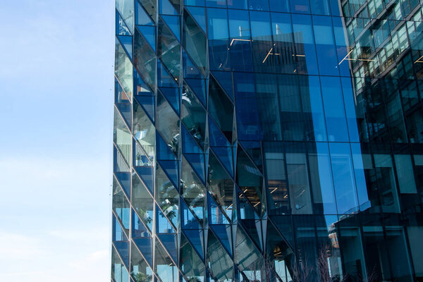 Reflection of modern architecture in windows of office building. Business background
