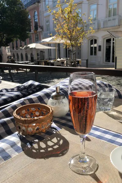 A glass of rose wine on the terrace of a cafe.