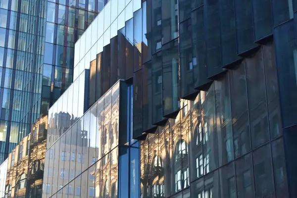 Reflection of buildings in the windows of a modern office building.