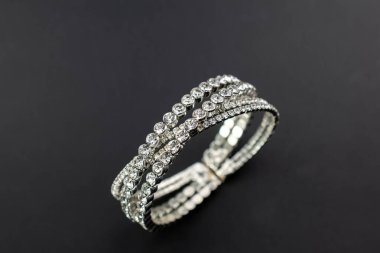 Bracelet with diamonds on a black background, close-up