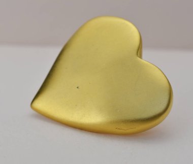 Beyaz arka planda altın kalpli broş. Sevgililer Günü. Aşk.