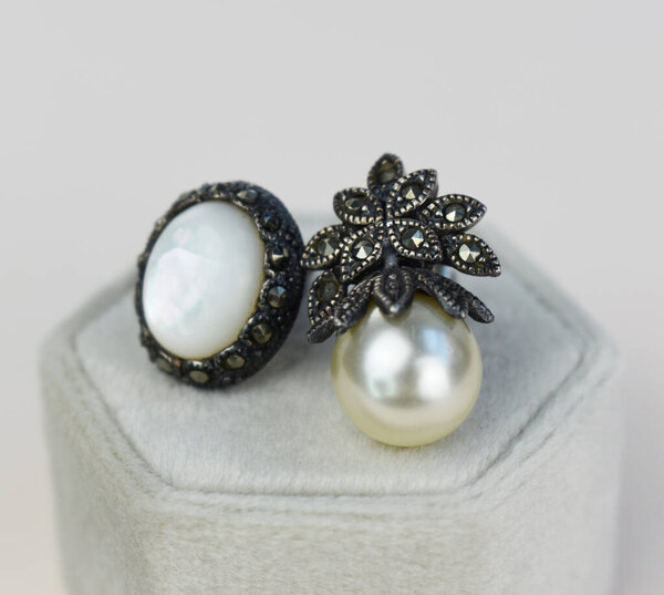 Jewelry ring with pearls in a box on white background