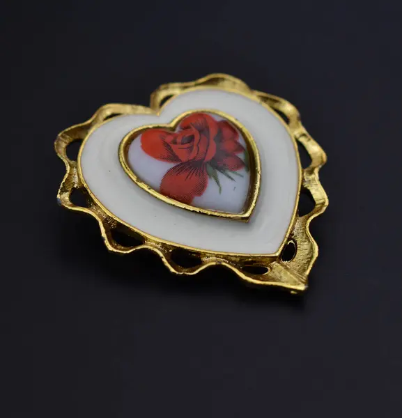 stock image Vintage brooch in the shape of a heart on a black background