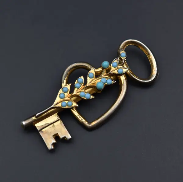 stock image Vintage key with blue sapphire gemstone on black background