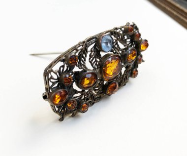 Beyaz arka planda değerli taşlı mücevher broşu.