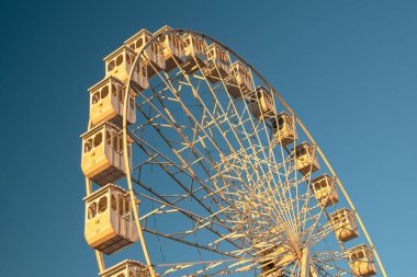 Mavi gökyüzü arka planında dönme dolap. Klasik stil tonlu resim