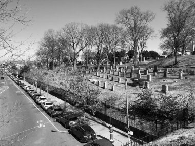 A view of a cemetery in New York City. Black and white. clipart