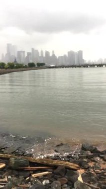 Suyun kenarına bakan Manhattan silüeti.