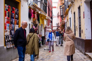 Tourists and locals walking in the streets of Seville, Andalusia, Spain clipart