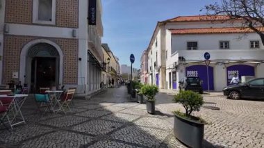 Güneşli hava Avrupa 'da okyanus kenti yakınlarındaki canlı tarihi binaların önünden geçiyor.