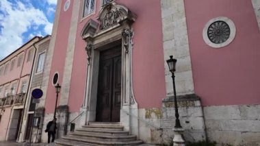 Lizbon 'u keşfeden dar sokaktaki POV, turistik şehirde tarihi binalar geziyor.