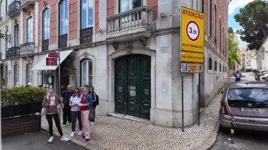 Lizbon 'da eski bir kasabada tramvaya binmek, dar bir sokak aşağıda, Portekiz' in ünlü seyahat şehrinde tarihi mimari.