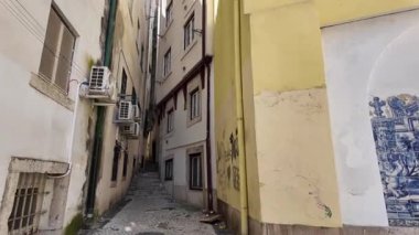 Lizbon 'da tarihi binalarla dolu dar kaldırımlı bir ara sokağı araştırıyorum.