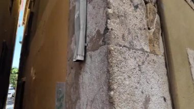 Tarihi Lizbon Portekiz caddesinde kaldırım taşları ve eski duvarlarla yürüyorum.