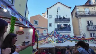 Happy faces in Lisbon streets enjoying Saint Anthony traditions