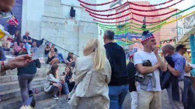 Joyful night in Lisbon celebrating Saint Anthony with traditional food and music