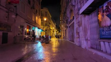 Yellow Lisbon street lights on stone path at night