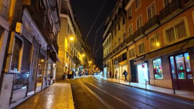 Dar Lizbon caddesinde gece sıcacık bir parıltı var. Geceleri Lizbon 'da boş bir sokak.