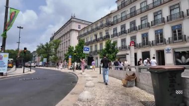 Daily life in Lisbon city center with people walking and summer vibes
