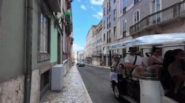 pov in sunny Lisbon Portugal walking tour of historic quarter with pastel buildings