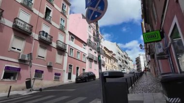 walking tour pov in summer Lisbon Portugal historic district bright walls
