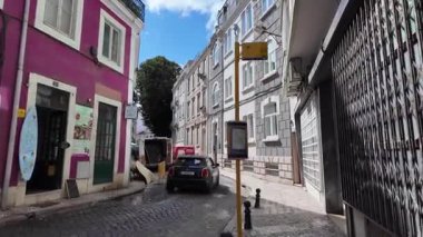 summer travel pov Lisbon Portugal walking through colorful streets in old town