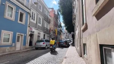 summer travel pov Lisbon Portugal walking through colorful streets in old town