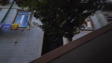 Central Lisbon evening stroll POV with historic architecture and glowing street lights