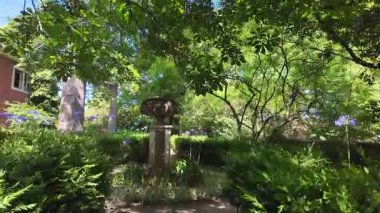 Walking in Lisbon park path summer day sunshine green trees Europe travel architecture holiday concept