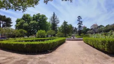 Lisbon public park walk summer trees sunlight POV travel Europe holiday background architecture