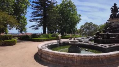 First person POV Lisbon park walkway summer green foliage Europe city architecture travel concept
