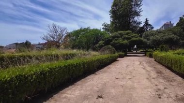 Lisbon park green trees bright sunshine POV walk summer Europe travel holiday concept background