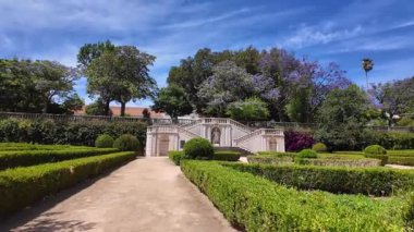 Walking through Lisbon park green trees sunshine Europe city architecture background vacation concept