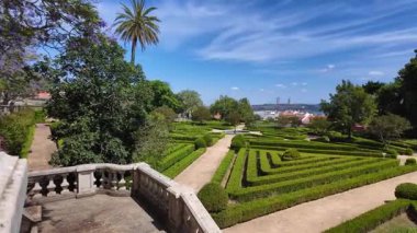 Walking path Lisbon park with green trees summer sunshine European travel architecture cityscape view