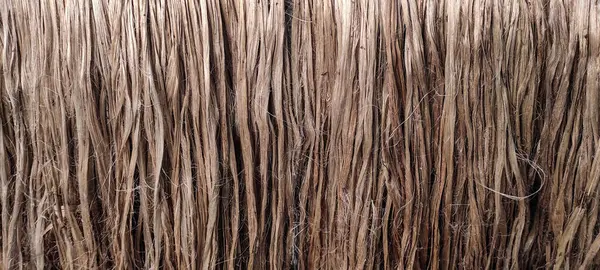 a close up photo of jute fiber Closeup shot, raw jute fiber hanging under the sun for natural drying