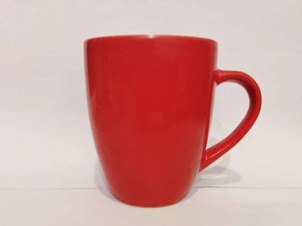 A picture of red mug at table with white background