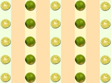 Yeşil turuncu ve yeşil arka planda limon deseni ve yarım dilim limon.