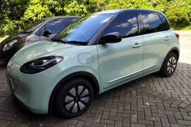 Jakarta, Indonesia - July 10, 2024: Green Wuling Bingo EV an electric vehicle at a parking lot clipart