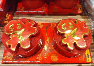 Jakarta, December 21, 2024: Aceh kue keranjang (basket cake) or nian gao, a sweet, chewy cake made from glutinous rice flour and brown sugar that is a traditional part of Chinese New Year celebrations clipart