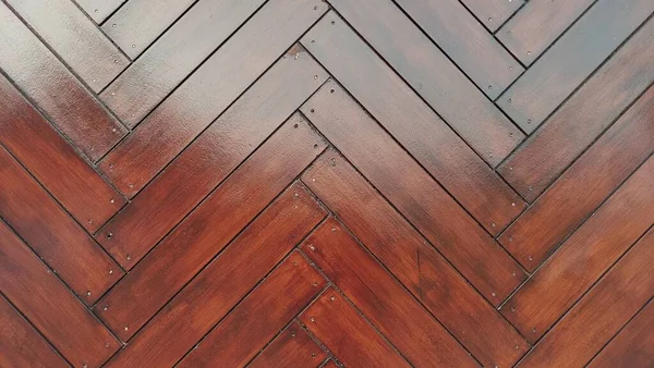 Old oak herringbone parquet with zigzag motif. Wooden floors, point de Hongrie style. Typical Parisian floor. Close-up herringbone style pattern in horizontal shot