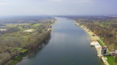 Belgrad 'ın banliyölerinde kurulmuş sakin mavi gölün güneşli gününün tadını çıkarın. Doğanın ve şehrin kenar mahallelerinin mükemmel bir uyum içinde olduğu bu manzaranın huzurunun tadını çıkarın..
