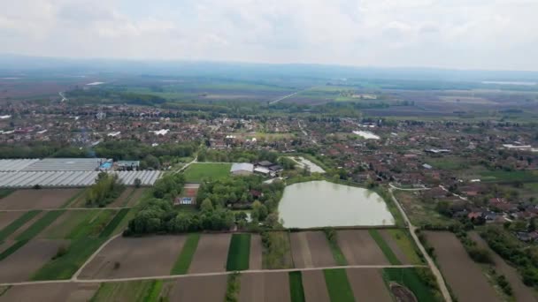 Luchtfoto Van Village Genesteld Tussen Uitgestrekte Landbouwvelden Met Grote Visvijver — Stockvideo
