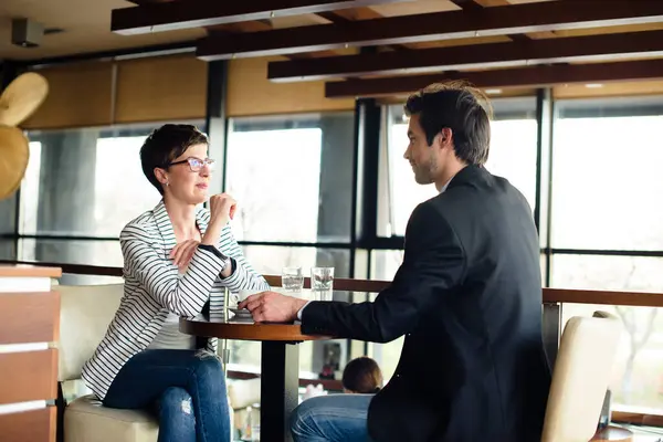 Man and woman talking on business meeting