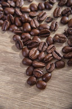 Coffee beans close up on wooden clipart